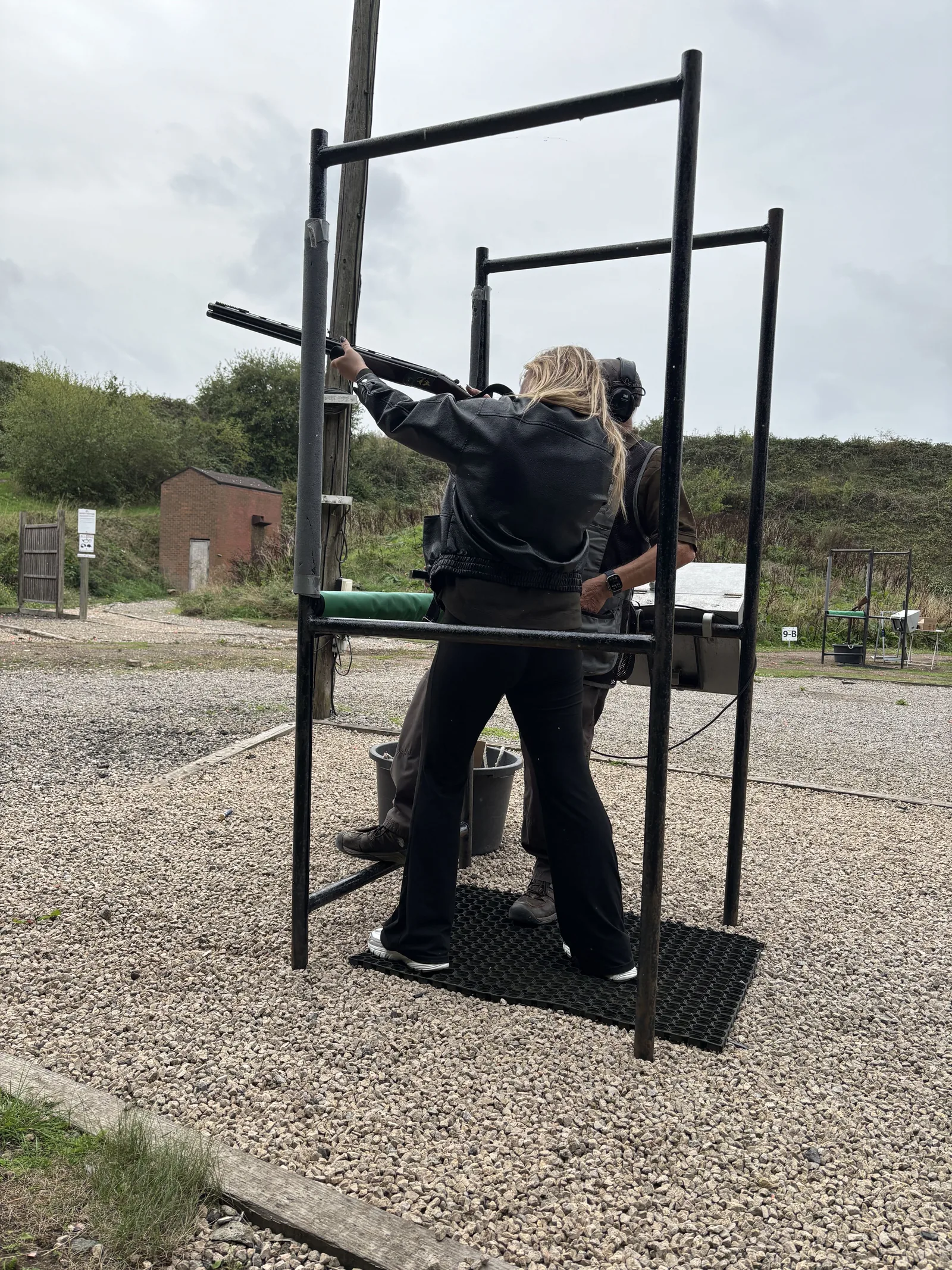 A participant taking aim at the clay shooting range